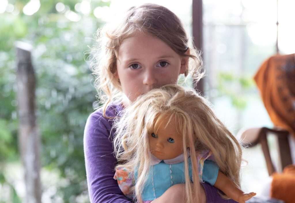 photo of child holding a doll