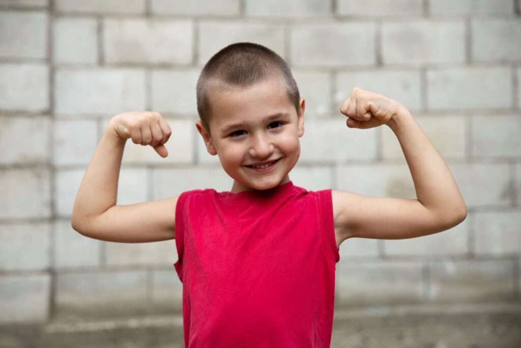 Moldovan boy shows his arm muscles